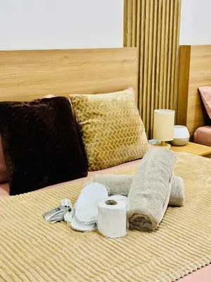a bed with a pile of towels on it at Shore 2 Residences Tower 1 in Manila