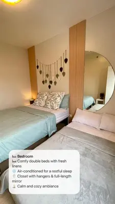 a hotel room with two beds and a mirror at A and A Place - The Hive C - Free Parking in Taytay