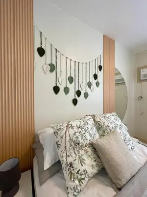 a bedroom with a bed with plants on the wall at A and A Place - The Hive C - Free Parking in Taytay