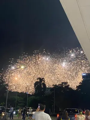 a group of people standing in front of a fireworks display at Shore 1 Residences Tower D Pasay in Manila
