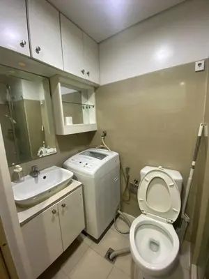 a small bathroom with a toilet and a sink at Shore 1 Residences Tower D Pasay in Manila