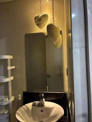 a bathroom with a sink and a mirror at Cozy haven across terminal 3 in Manila