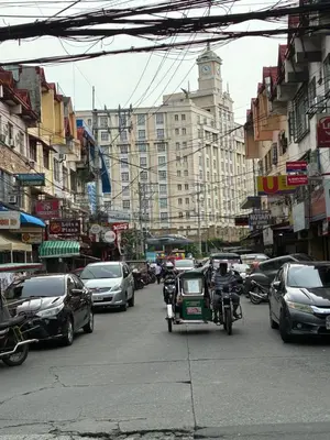 a busy city street filled with lots of traffic at Cozy haven across terminal 3 in Manila