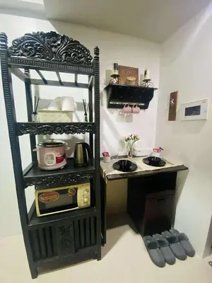 a small kitchen with a stove and a sink at Cozy Haven Across Terminal 3 in Manila