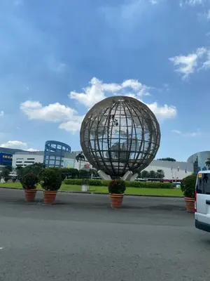 a metal sphere in a parking lot with potted plants at Shore 1 Spacious Smart Home 3C in Manila