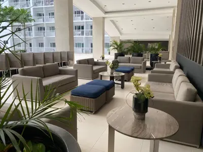 a lobby with couches and tables in a building at Shore 1 Spacious Smart Home 3C in Manila