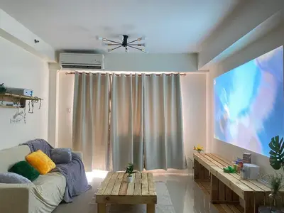 a living room with a large flat screen tv at 2BR walking distance to MOA - near PICC,NAIA,STAR CITY by JBCO Staycation Jha in Manila