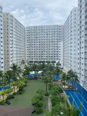 an aerial view of a resort with a pool and palm trees at 2BR walking distance to MOA - near PICC,NAIA,STAR CITY by JBCO Staycation Jha in Manila