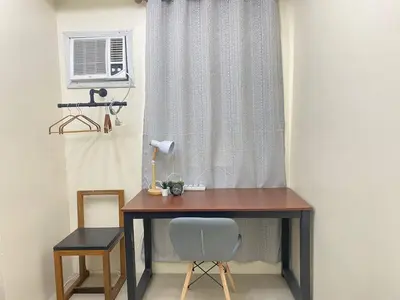 a desk with a chair next to a window at 2BR walking distance to MOA - near PICC,NAIA,STAR CITY by JBCO Staycation Jha in Manila