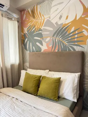 a bedroom with a bed with a colorful wall at Erin Serenity Harbor in Manila