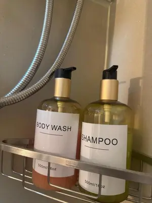 two bottles of body wash and shampoos on a shelf at Erin Serenity Harbor in Manila
