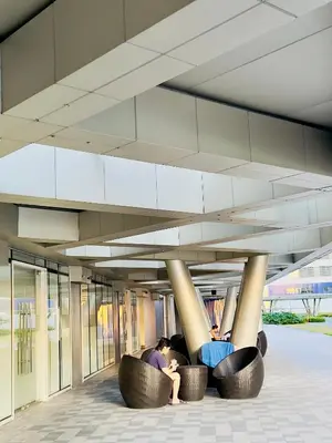 two people sitting in chairs under a building at Erin Serenity Harbor in Manila