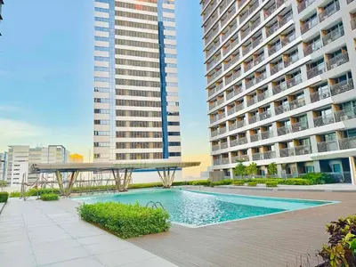 a swimming pool in front of two tall buildings at Erin Serenity Harbor in Manila