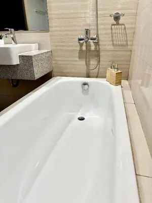 a white bath tub in a bathroom with a sink at Modern 3BR 180 Degree Seaview Beside Okada Manila 14 in Manila