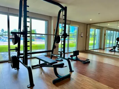 a gym with two tread machines in a room at Modern 3BR 180 Degree Seaview Beside Okada Manila 14 in Manila