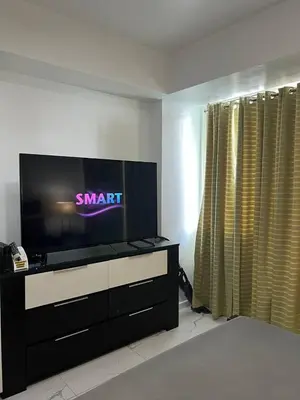 a living room with a large flat screen tv at Azure Resort and Staycation by Miss Angie in Manila