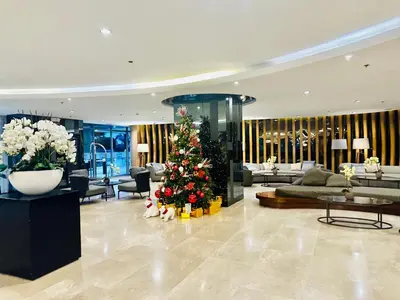 a christmas tree in the middle of a lobby at Shore Bliss Staycation MOA in Manila