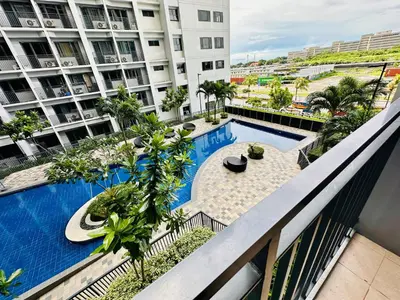 a view of the pool from the balcony of a building at Shore Bliss Staycation MOA in Manila