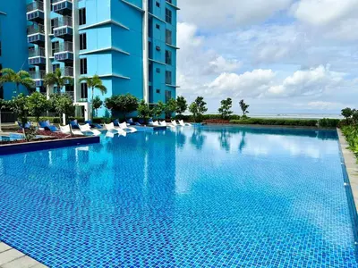 a large swimming pool next to a tall building at Modern 1Bedroom Direct ManilaBay SeaView Okada Airport Spacious in Manila