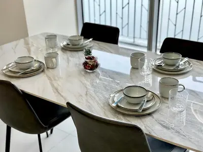 a table with plates and napkins on top of it at Modern 1Bedroom Direct ManilaBay SeaView Okada Airport Spacious in Manila