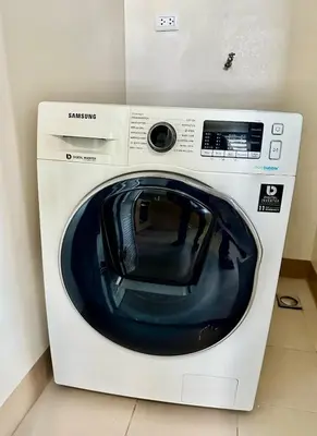 a white washing machine sitting in a room at Modern 1Bedroom Direct ManilaBay SeaView Okada Airport Spacious in Manila