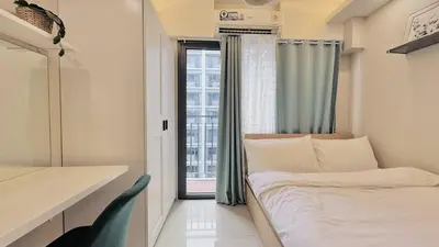 a small bedroom with a bed and a window at 1 Bedroom Apartment in Pasay near MOA in Manila