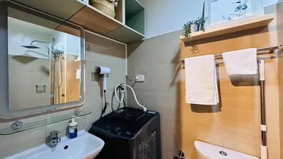 a bathroom with a sink and a mirror at 1 Bedroom Apartment in Pasay near MOA in Manila