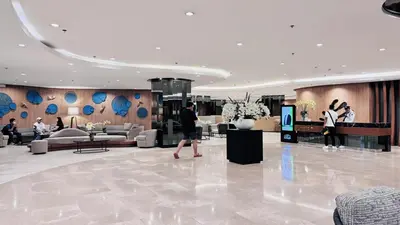 a man walking through a lobby of a hotel at 1 Bedroom Apartment in Pasay near MOA in Manila