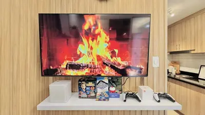 a tv on a wall with a fire on it at 1 Bedroom Apartment in Pasay near MOA in Manila