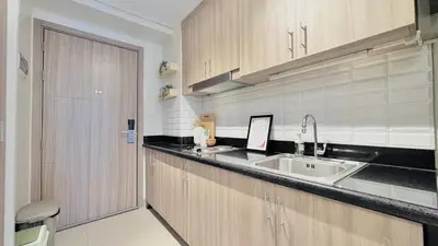 a kitchen with a sink and a counter top at 1 Bedroom Apartment in Pasay near MOA in Manila