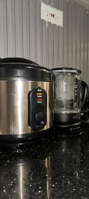 a slow cooker and a toaster on a counter at GreyKey Stays at the 34th in Manila