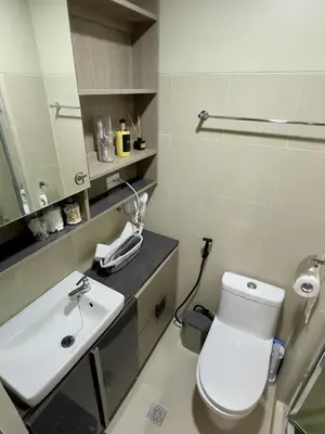 a bathroom with a white toilet and a sink at GreyKey Stays at the 34th in Manila