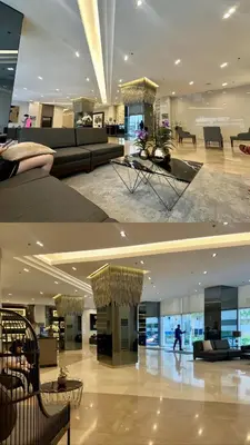 a large lobby with couches and tables in a building at GreyKey Stays at the 34th in Manila