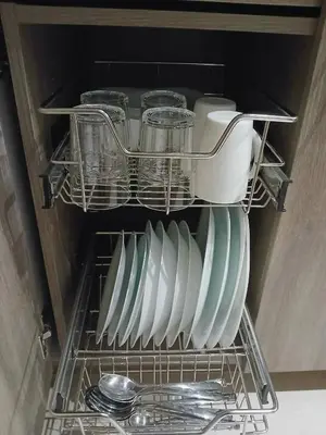 a dish rack with dishes and utensils in a refrigerator at GreyKey Stays at the 34th in Manila