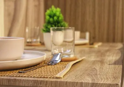 a table with a glass and a plate and a spoon at Japandi - Inspired Staycation MOA Pasay City in Manila