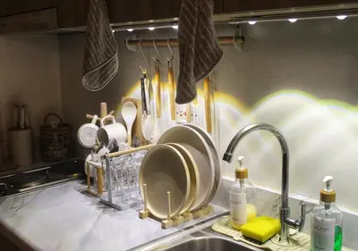 a kitchen sink with plates and utensils at Japandi - Inspired Staycation MOA Pasay City in Manila
