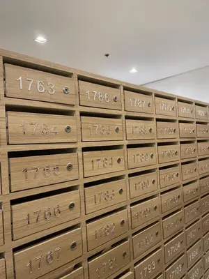 a wall of wooden boxes with numbers on them at Japandi - Inspired Staycation MOA Pasay City in Manila