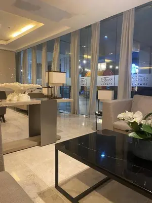 a lobby with a couch and a table and chairs at Cabin and a cozy stay near MOA in Manila