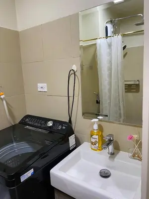 a bathroom with a sink and a stove at Cabin and a cozy stay near MOA in Manila