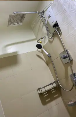 a shower stall in a bathroom with a sink at Cabin and a cozy stay near MOA in Manila