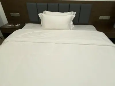 a large white bed with white sheets and pillows at MOA Home For Family Trips & Getaways Kitchen-505 in Manila