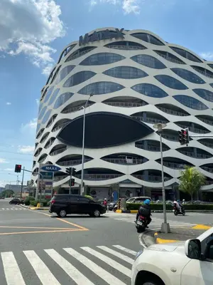 a large building with cars parked in front of it at MOA Home For Family Trips & Getaways Kitchen-505 in Manila