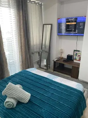 a bedroom with a bed with a teddy bear on it at Condo in Paranaque City Homes Azure in Manila