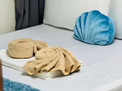 a bed with two towels and a blanket on it at Shore 3 Residences Poolside Room 245 by Prime Stay MOA in Manila
