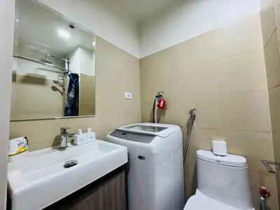 a bathroom with a toilet and a sink at Shore 3 Residences Poolside Room 245 by Prime Stay MOA in Manila