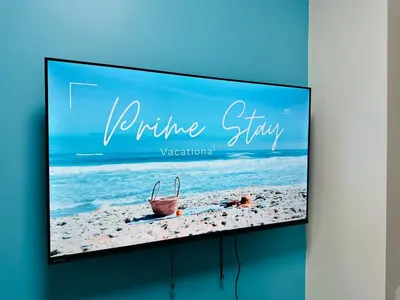 a television screen with a picture of the beach at Shore 3 Residences Poolside Room 245 by Prime Stay MOA in Manila