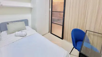 a bedroom with a bed and a blue chair at 2 Bedroom Rental Apartment in Pasay in Manila