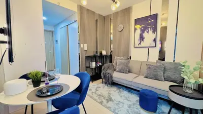 a living room with a couch and a table and chairs at 2 Bedroom Rental Apartment in Pasay in Manila