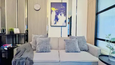 a white couch with pillows in a living room at 2 Bedroom Rental Apartment in Pasay in Manila