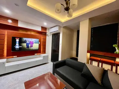 a living room with a couch and a flat screen tv at Apartment Taguig Makati staycation with parking in Manila